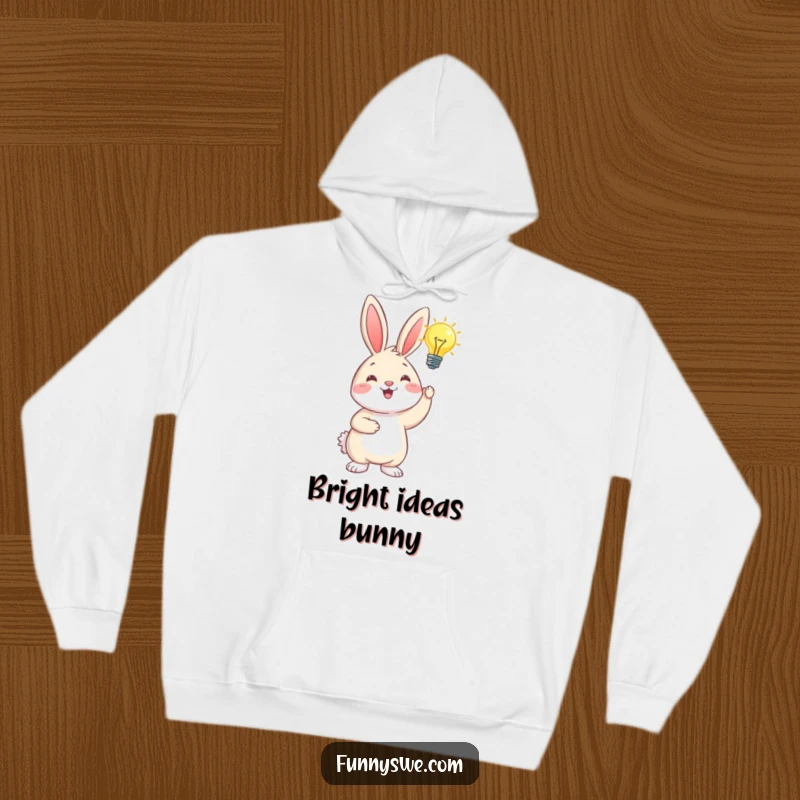 Funny happy bunny holding a glowing lightbulb, representing inspiration, a cozy and humorous hoodie for creative thinkers.